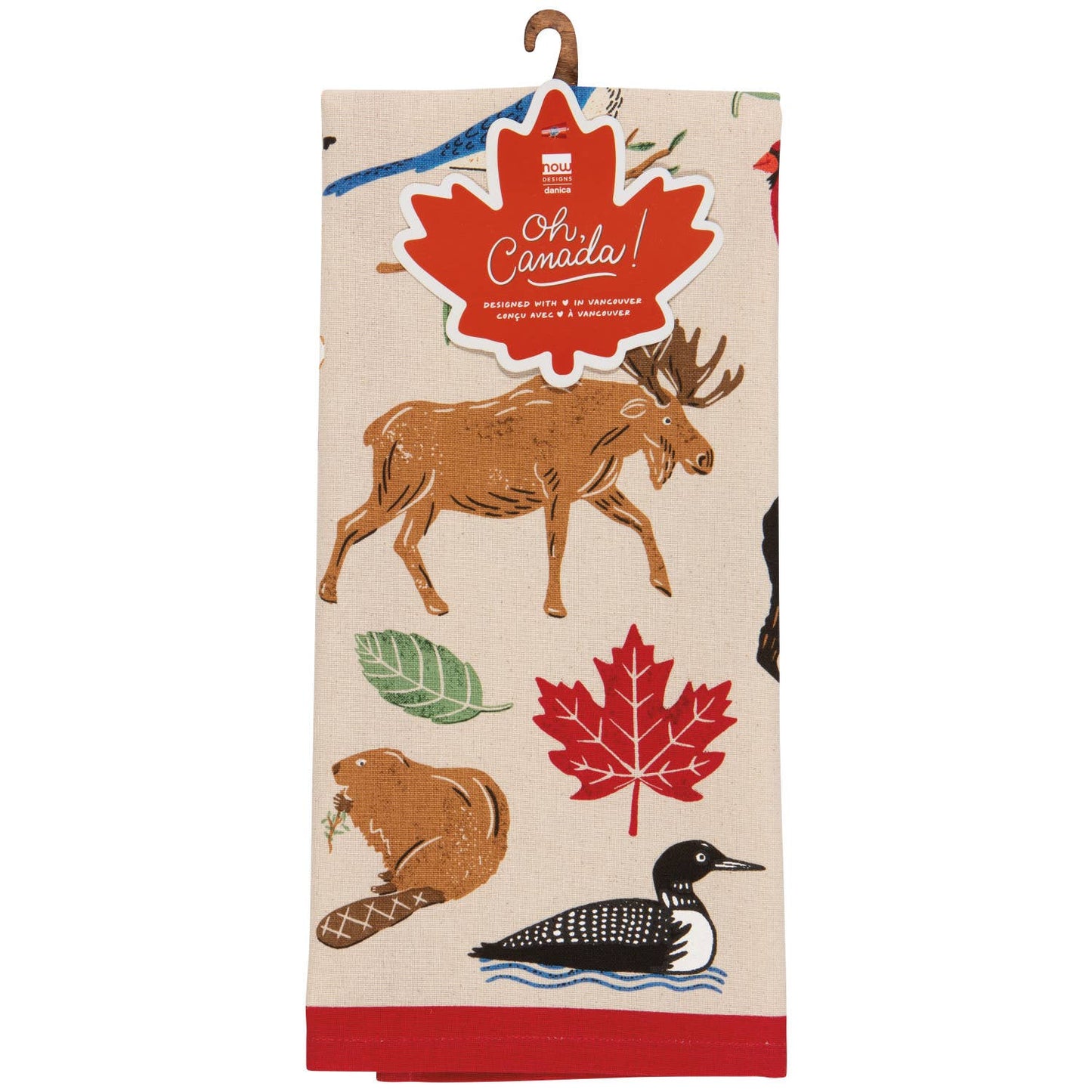 Tea towel with Canadian-themed design featuring a moose, beaver, loon, and maple leaf on a beige background.